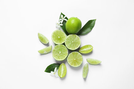 Limes, flowers and leaves on white background, top view. Citrus fruitsの写真素材