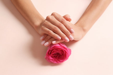 Close up view of woman with rose on color background. spa treatmentの写真素材