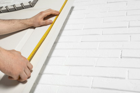 Man measuring door in room, closeup. construction toolの写真素材