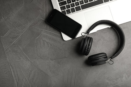 Flat lay composition with headphones, laptop and smartphone on table. Space for textの写真素材