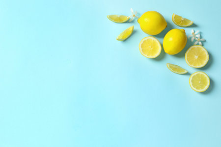 Frame made of lemons and flowers on color background, flat lay with space for text. Citrus fruitsの写真素材