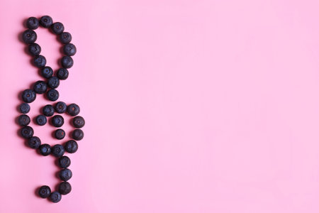 Treble clef made of bilberries on color background, top view with space for text. creative musical notesの写真素材