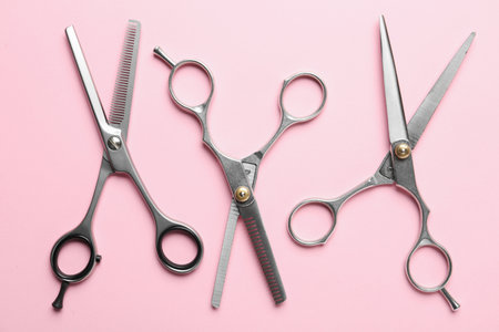 Flat lay composition with scissors on color background. hairdresser tools