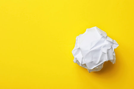 Crumpled sheet of paper on color background, top view. Space for textの写真素材