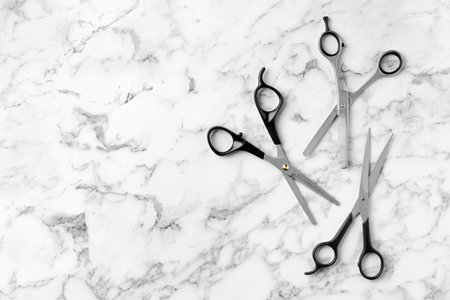 Flat lay composition with scissors and space for text on marble background. hairdresser toolsの写真素材