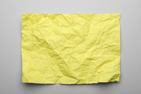 Color sheet of crumpled paper on gray background, top viewの写真素材