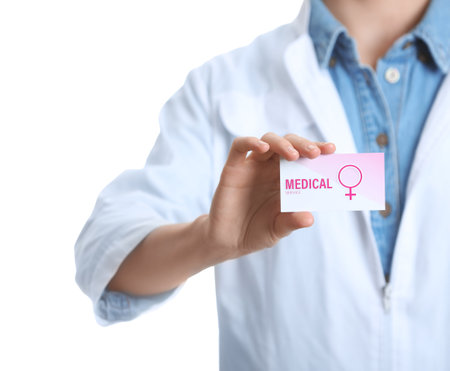 Doctor holding medical business card isolated on white, closeup. Women's health servicesの写真素材