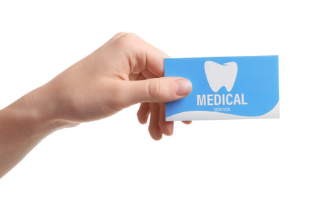 Woman holding business card isolated on white, closeup. dental medical serviceの写真素材
