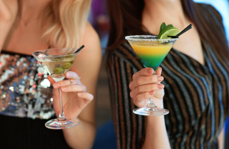 Young women with martini cocktails in bar, closeupの写真素材