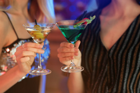 Young women with martini cocktails in bar, closeupの写真素材