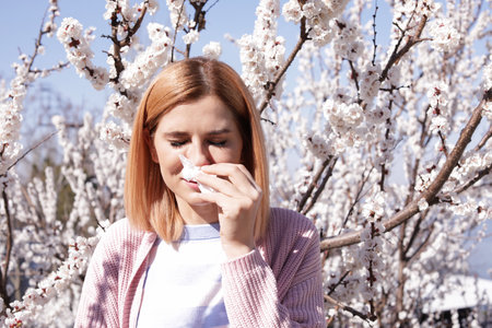 Woman suffering from seasonal allergy outdoors, space for textの写真素材