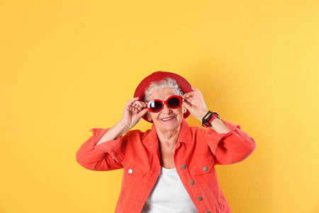 Portrait of cool grandmother on color backgroundの写真素材