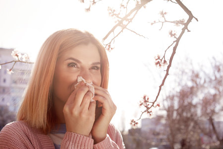Woman suffering from seasonal allergy outdoors, space for textの写真素材