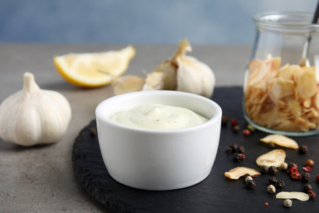 Composition with garlic sauce on gray tableの写真素材