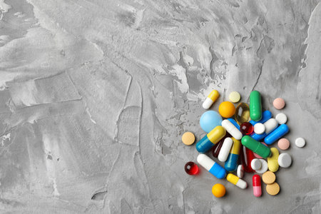 Heap of different pills on table, top view. Space for textの写真素材