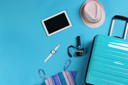 Flat lay composition with suitcase and accessories on color background, space for text. summer holidaysの写真素材