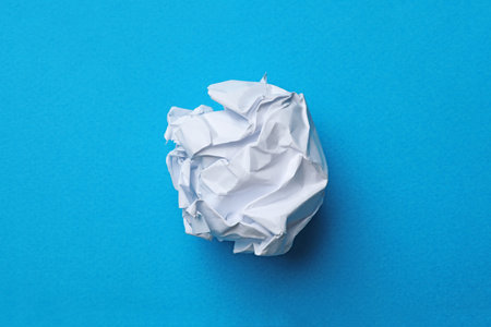 Crumpled sheet of paper on color background, top viewの写真素材