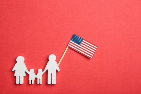 Flat lay composition of family figure with USA flag on color background. Happy Independence Dayの写真素材