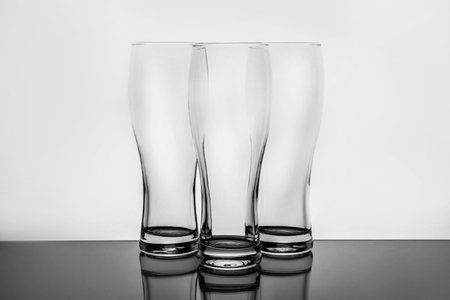 Empty clear beer glasses on white backgroundの写真素材