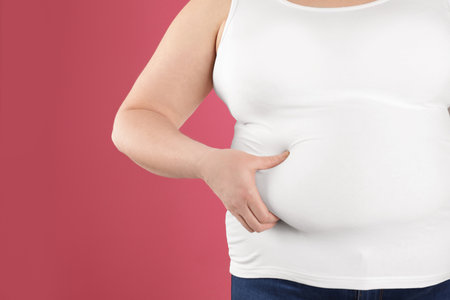 Overweight woman on color background, closeup. Space for textの写真素材