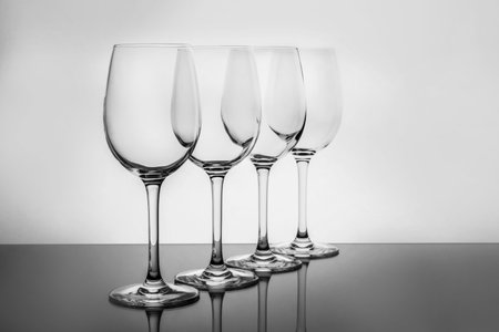 Row of empty wine glasses on white backgroundの写真素材