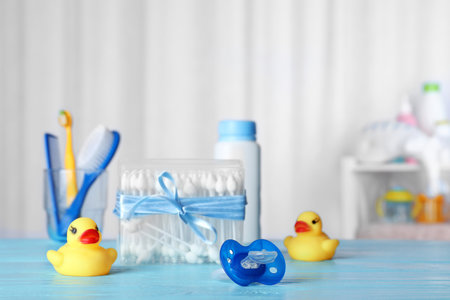 Baby accessories and toys on table against light background. Space for textの写真素材