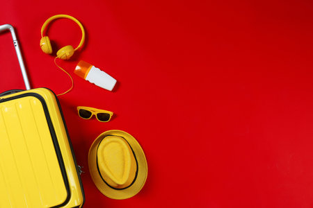 Flat lay composition with stylish suitcase and accessories on color background. Space for textの写真素材