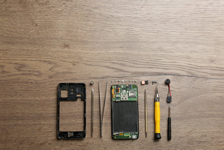 Disassembled mobile phone and repair tools on table, flat lay. Space for textの写真素材