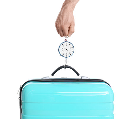 Man weighing stylish suitcase against white background, closeupの写真素材
