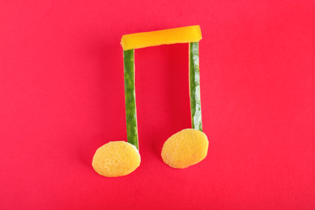 Musical note made of vegetables and fruits on color background, top viewの写真素材
