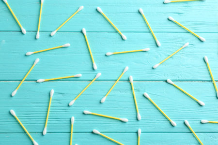 Flat lay composition with cotton swabs on wooden backgroundの写真素材