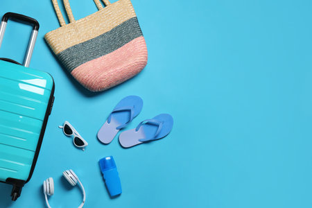 Flat lay composition with suitcase and accessories on color background, space for text. summer holidaysの写真素材