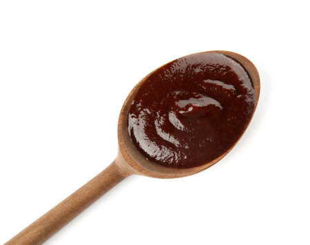 Spoon with hot barbecue sauce on white backgroundの写真素材