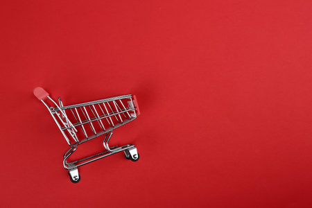 Empty shopping trolley on color background, top view. Space for textの写真素材