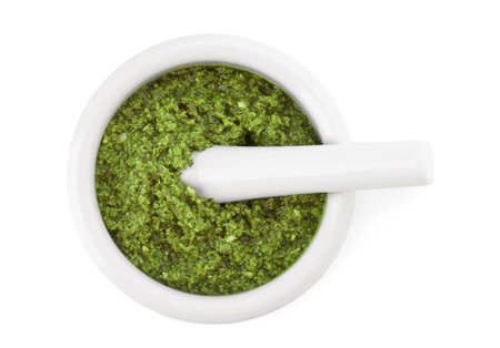 Mortar of tasty pesto sauce and pestle isolated on white, top viewの写真素材