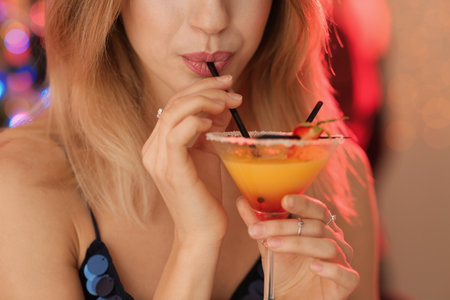 Young woman with glass of martini cocktail at party, closeupの写真素材