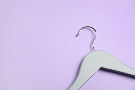 Empty wooden clothes hanger on color background. Space for textの写真素材