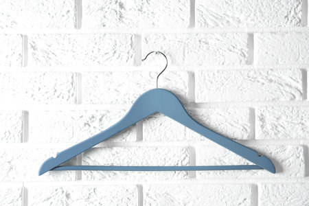 Empty clothes hanger on brick wall. Wardrobe accessoryの写真素材