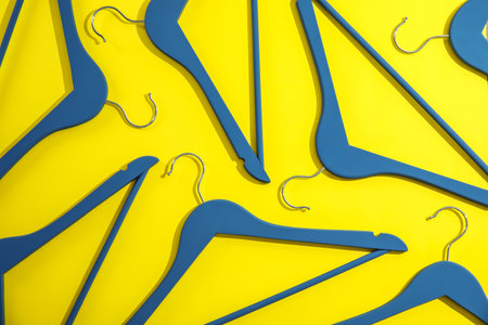 Flat lay composition with empty hangers on color backgroundの写真素材