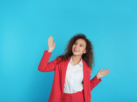 Portrait of emotional African-American businesswoman on color backgroundの写真素材