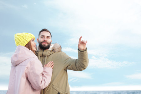 Lovely young couple spending time near the sea