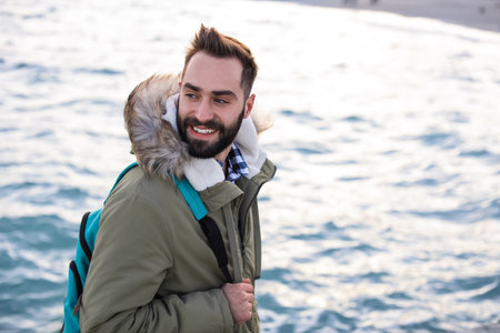 Stylish young man with backpackの写真素材