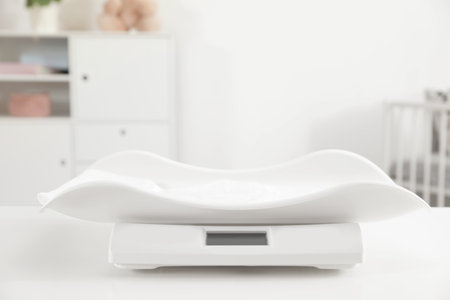 Modern digital baby scales on table in room. Space for textの写真素材