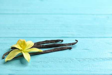 Vanilla sticks and flowers on wooden background. Space for textの写真素材