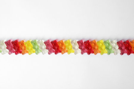 Row of delicious jelly bears on white background, top viewの写真素材