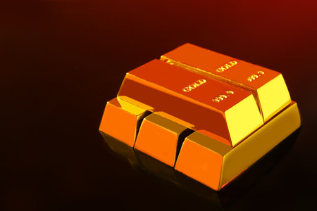 Precious shiny gold bars on mirror surface, space for textの写真素材