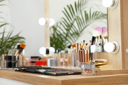 Set of luxury makeup products and accessories on dressing table with mirror. Space for textの写真素材