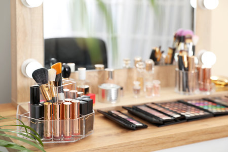 Set of luxury makeup products on dressing table with mirror. Space for textの写真素材