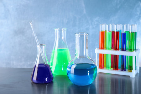 Different glassware with samples on table in chemistry laboratoryの写真素材
