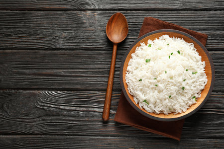 Plate of tasty cooked rice served on table, flat lay. Space for textの写真素材